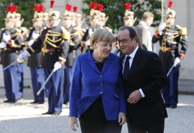 French President Francois Hollande (R) chats with German Chancellor Angela Merkel (L) on her arrival at the Elysee Palace to take part in Normandy Quartet summit on Ukrainian crisis in Paris.