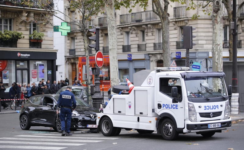 French police prepare to tow off a suspected car parked on Boulevard Ornanon as part of a massive police investigation operations in Paris