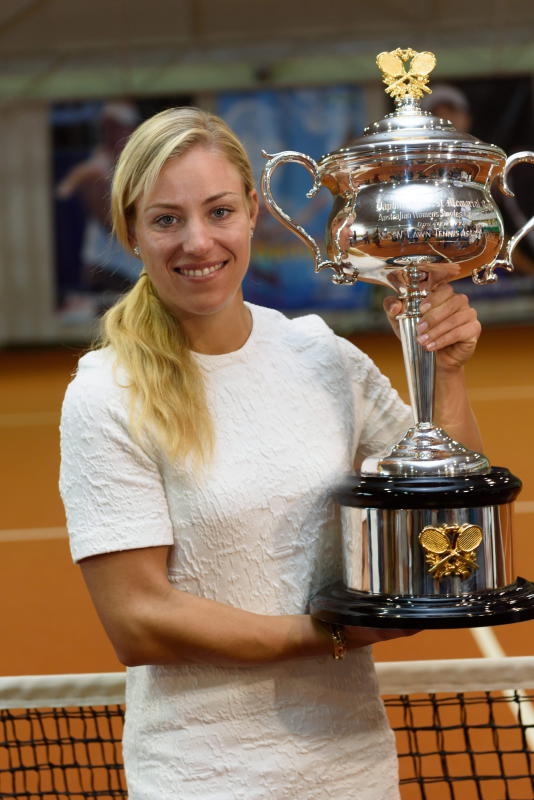 Angelique Kerber of Germany poses for the photographers with her Australian Open women's singles trophy
