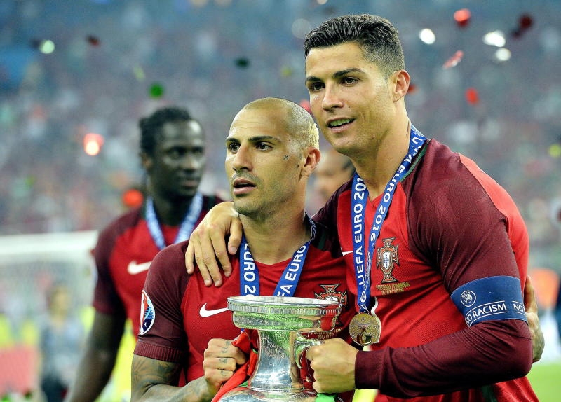 Cristiano Ronaldo of Portugal (R) and teammate Ricardo Quaresma hold the trophy after winning the UEFA EURO 2016 Final match between Portugal and France at Stade de France in Saint-Denis, France, 10 July 2016. (RESTRICTIONS APPLY: For editorial news reporting purposes only. Not used for commercial or marketing purposes without prior written approval of UEFA. Images must appear as still images and must not emulate match action video footage. Photographs published in online publications (whether via the Internet or otherwise) shall have an interval of at least 20 seconds between the posting.) (c) dpa