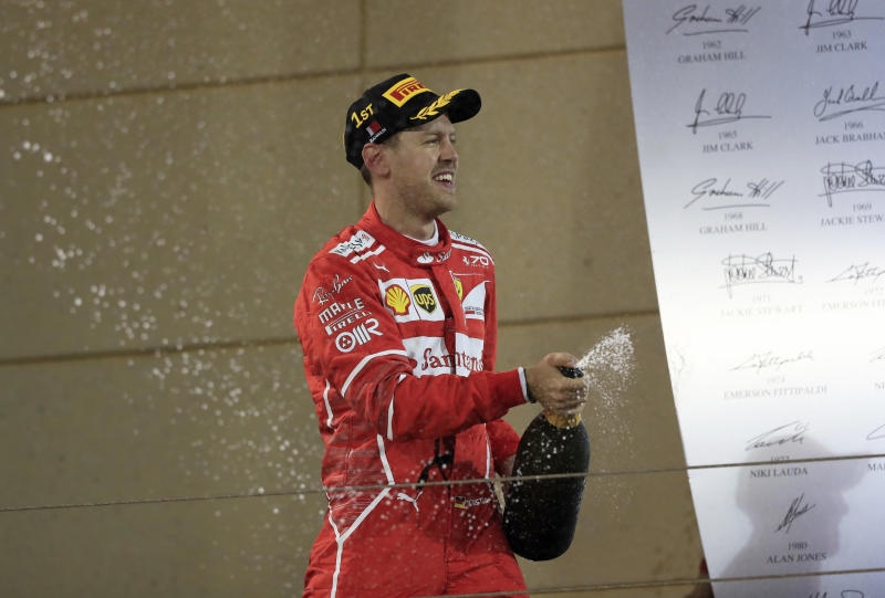 <p>Motorsport: Formel-1-Weltmeisterschaft, Rennen, Grand Prix von Bahrain am 16.04.2017 in as-Sachir (Bahrain). Der Deutsche Sebastian Vettel vom Team Scuderia Ferrari jubelt auf dem Podium nach seinem Grand-Prix-Sieg. Foto: Luca Bruno/AP/dpa +++(c) dpa - Bildfunk+++</p>