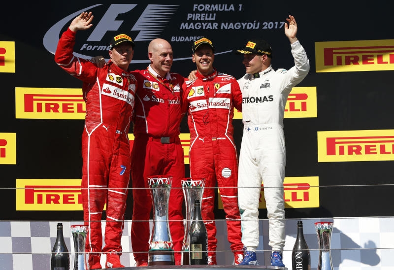 <p>Motorsport: Formel-1-Weltmeisterschaft, Grand Prix von Ungarn, Rennen am 30.07.2017 in Budapest (Ungarn). Der Finne und Zweitplatzierte Kimi Räikkönen (l) vom Team Scuderia Ferrari schaut auf dem Podium seinen Teamkollegen, der Deutsche und Erstplatzierte Sebastian Vettel (r), in die Augen an.</p>