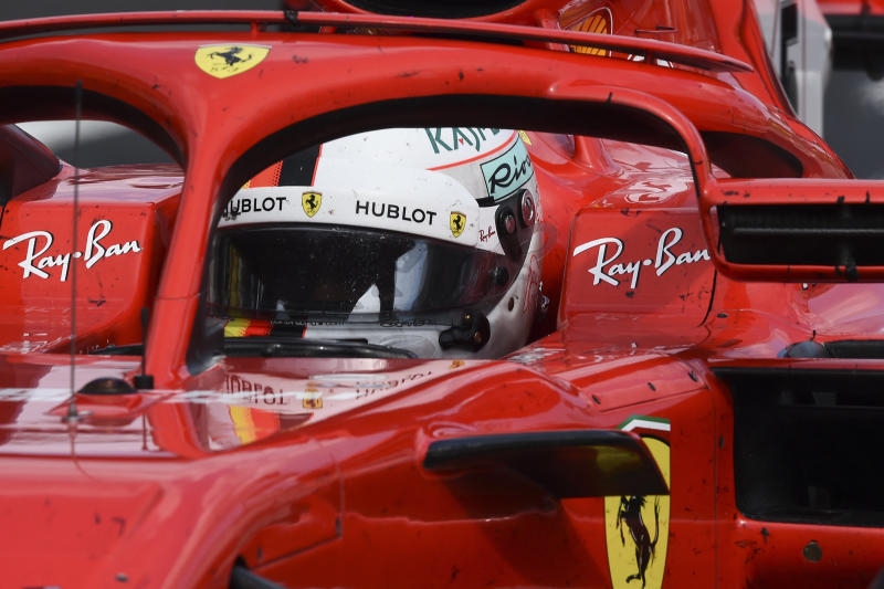 <p>28.06.2018, Österreich, Spielberg: Formel 1: Vor dem Großen Preis von Österreich: Der Deutsche Sebastian Vettel vom Team Scuderia Ferrari geht während der Rennvorbereitungen durchs Fahrerlager am Red Bull Ring in Spielberg. Der Große Preis von Österreich findet am 01.07.2018 statt. Foto: Herbert Neubauer/APA/dpa +++ dpa-Bildfunk +++</p>