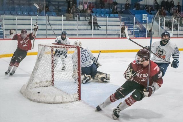 <p>Ryan MacDonald (left) celebrates after scoring the game winner for the Coyotes in the second period of overtime Saturday. Bryson Garska, who assisted, skates away in the lower right.</p>